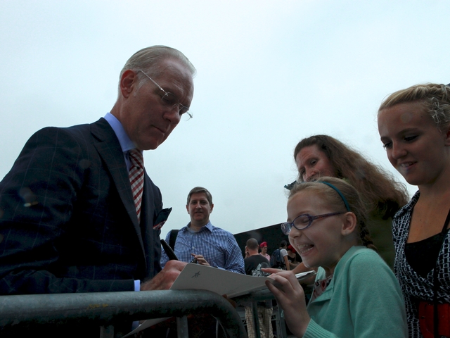 Tim Gunn signs the portfolio for Bebe Wood.