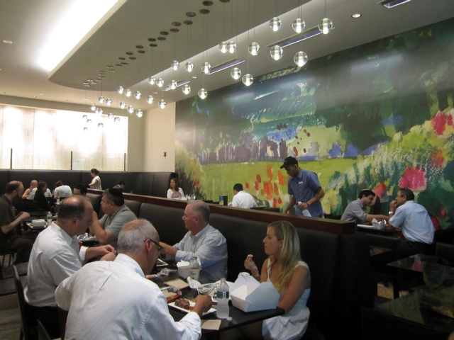 The new Milk Street Cafe includes a large mural of its logo, a painting meant to symbolize freshness.