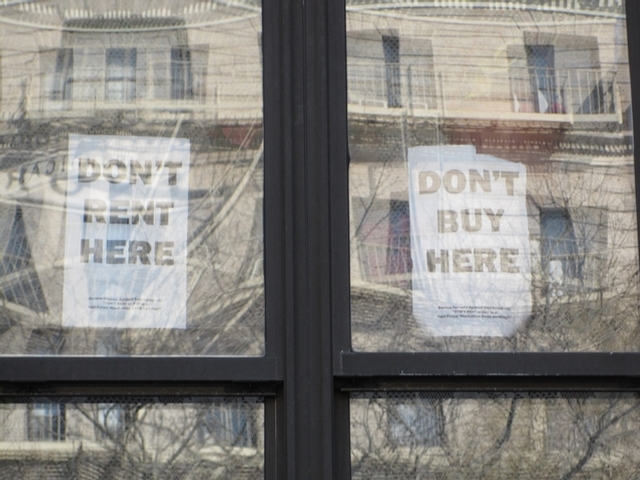 Tahl Propp tenants posted protest signs in the windows of their apartments.
