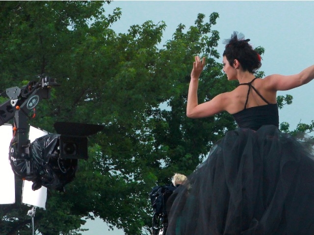 A model shows off a dark-colored dress.
