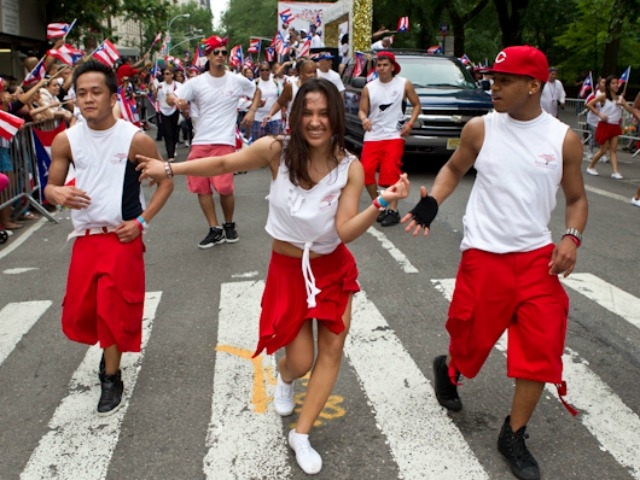Dancers  enjoy the parade on Fifth Avenue.