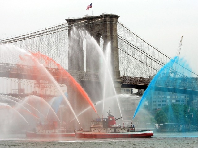 FDNY fireboats spray red, white and blue water beneath the Brooklyn Bridge during the Blessing of the FDNY Marine Fleet and Flag Day celebration at South Street Seaport June 14, 2006.