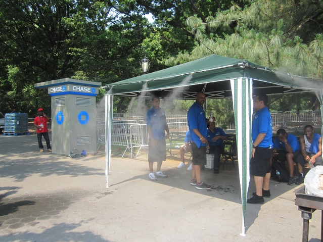 Workers for Thursday's Black Eyed Peas Central Park concert try to keep cool.