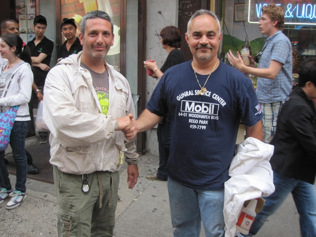 NYPD beekeeper Tony Planakis (r.) and Andrew Cote of the NYC Beekeepers Association shook hands after their successful rescue effort.
