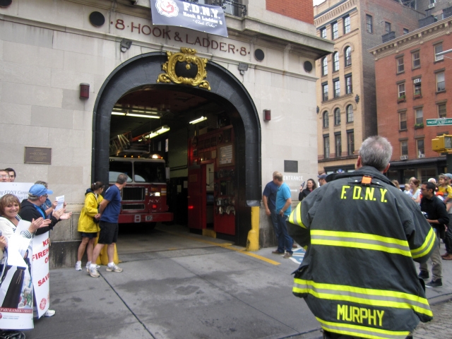 The crowd scattered as the Ladder 8 truck prepared to respond to a call.