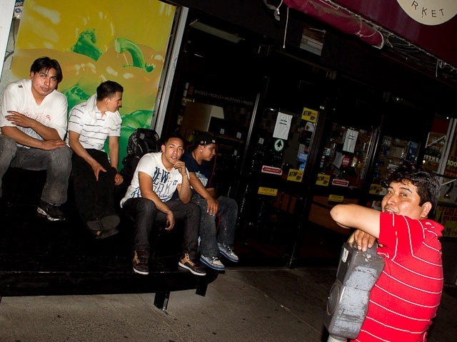 Residents relax on the street, waiting to be allowed back into their homes.