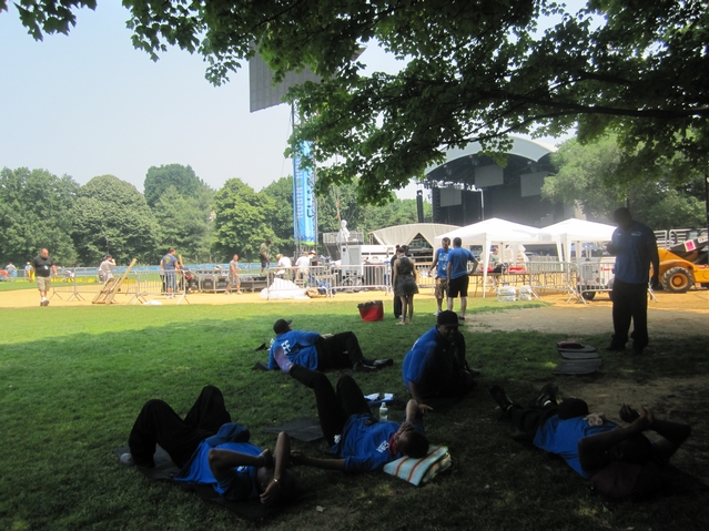 Workers rest before Thursday's Black Eyed Peas show.