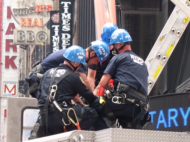 NYPD arrest a man who was atop a traffic light on Tuesday morning for nearly two hours.