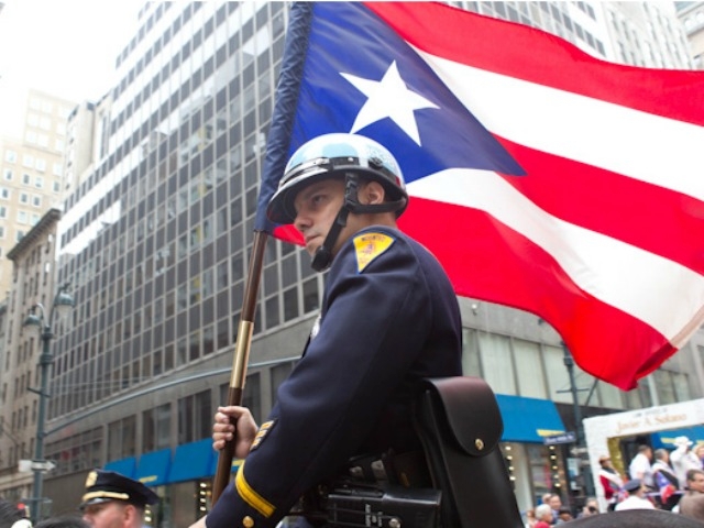 A mounted unit cop displays the flag of Puerto Rico.