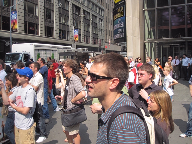 People assemble on the northwest corner of Broadway and 44th as a man was on top of light post, refusing to come down.