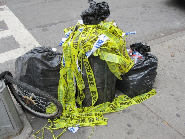Police tape filled a garbage can at the corner of Pitt and Rivington streets.