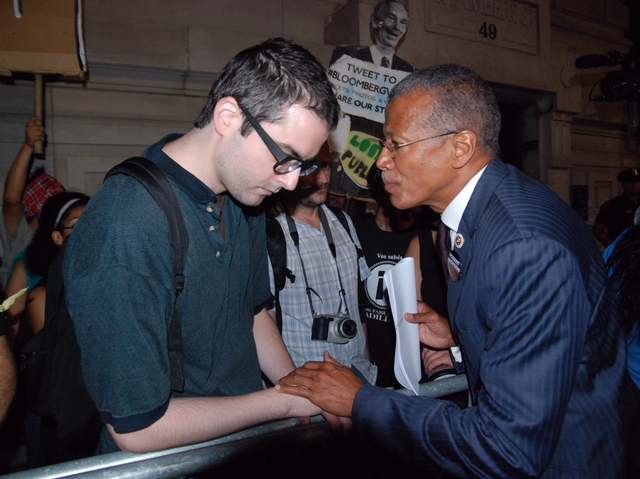 City Councilman Robert Jackson tries to explain to protester Mike Doja, 31, from Brooklyn, why he plans to vote in favor of a budget that contains such deep cuts.