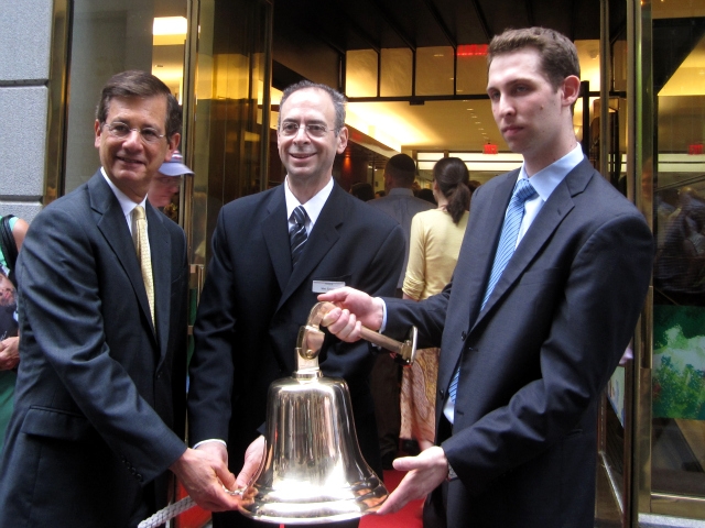 Deputy Mayor Stephen Goldsmith and Milk Street Cafe owner Marc Epstein, center, ring a bell to open the cafe.