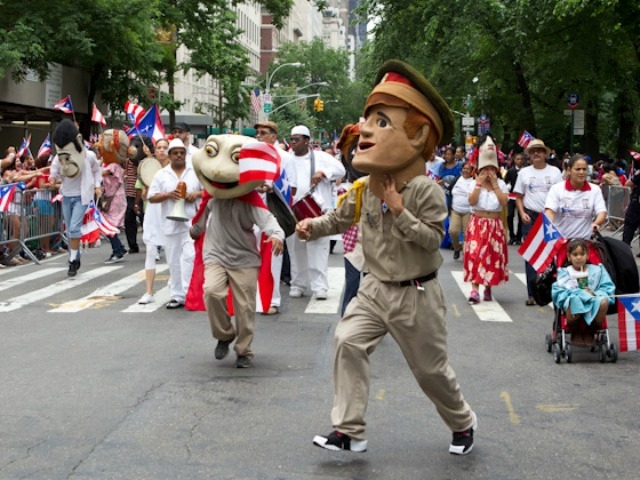 Costumed dancers take to Fifth Avenue.