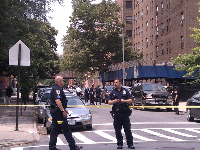 Cops investigate a shooting at 112 E. 128th St. in East Harlem Wednesday afternoon.