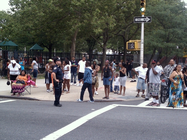 Crowd gathers at the scene of Wednesday's double shooting.
