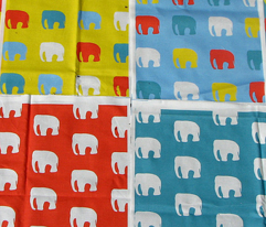 Multicoloured elephants on blue