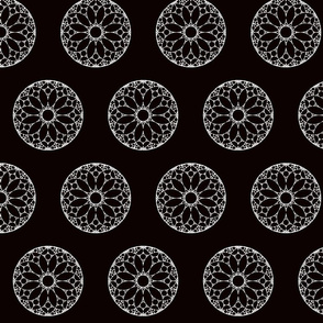 White lace doilies on black background