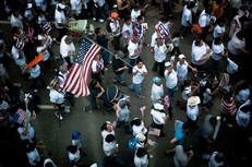 A demonstrator marches through the streets of downtown Dallas to protest the passage of Arizona's controversial new immigration law.