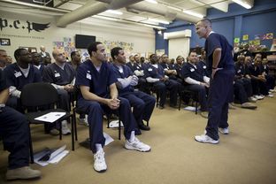 Morgan Crocker delivers a business proposal for a fitness training service during the weekly session of the Prison Entrepreneurship Program at the Cleveland Correctional Center in Cleveland, Texas.