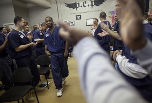 Brandon Biko Reese, who will soon be released after serving a five-year sentence, is enthusiastically welcomed to the front of the room to give a farewell speech. In an effort to "de-gangsterize" inmates, administrators encourage them to dance and cheer for their peers whenever possible.