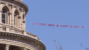 Airplane buzzed over the Capitol during the lunch hour with banner from the Texas Association of Business asking "Is 37 % correct on algebra too hard?"