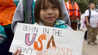 Six year old girl, holds up sign during immigration reform rally at the Texas Capitol on February 22nd, 2013