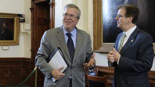 Education consultant and former Florida Gov. Jeb Bush, l, visits with Sen. Dan Patrick, R-Houston, before the Senate Education Committee on Feb. 27, 2013.