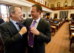 Rep. Ron Simmons R-Carrollton and Rep. Oscar Longoria D-Mission show off their purple ties on Purple Thursday at the Texas Capitol.