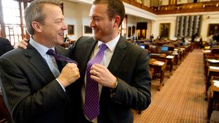 Rep. Ron Simmons R-Carrollton and Rep. Oscar Longoria D-Mission show off their purple ties on Purple Thursday at the Texas Capitol.