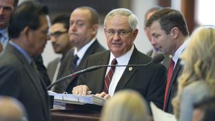 Bill sponsor State Rep. Jimmie Don Aycock, R-Killeen, is surrounded by members at the front mike while debate continues on HB 5 on March 26, 2013.