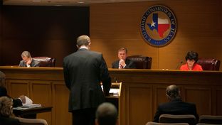 The Texas Railroad Commission, comprised of Chairman Barry T. Smitherman (center), and commissioners David Porter (left) and Christi Craddick (right) hold an open meeting in Austin, Texas on Jan. 15, 2013.