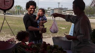Tiger Whitehead and his children Logic and Domnick, who use SNAP and the the Sustainable Food Center Farmer's Market double dollars coupons, shopping at the Tuesday afternoon Farmer's Market at 2835 East MLK Blvd., Austin, Texas, on March 19, 2013.