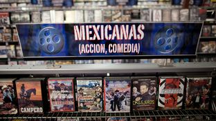 Low-budget movies about narcos, or Mexican drug dealers, are displayed on a shelf in Video Mexico, a video rental store in Austin.