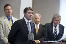 Gov. Rick Perry announces a 5 percent cut in the Texas franchise tax for small business on April 15, 2013. In the background are Rep. Harvey Hildebran, R-Kerrville, Gary Farmer of the Austin Chamber and MIke Morrissey of the governor's staff.