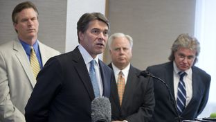 Gov. Rick Perry announces a 5 percent cut in the Texas franchise tax for small business on April 15, 2013. In the background are Rep. Harvey Hildebran, R-Kerrville, Gary Farmer of the Austin Chamber and MIke Morrissey of the governor's staff.