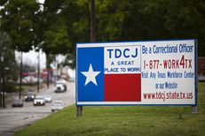 A sign outside of the Texas Department of Criminal Justice Headquarters in Huntsville. Last year, Texas prison officials approved a $3,000 bonus for correctional officers in units where a boom in oil and gas jobs has made it hard to find new hires. They are currently working with state lawmakers to grant all correctional officers a 5 percent pay increase.