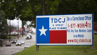 A sign outside of the Texas Department of Criminal Justice Headquarters in Huntsville. Last year, Texas prison officials approved a $3,000 bonus for correctional officers in units where a boom in oil and gas jobs has made it hard to find new hires. They are currently working with state lawmakers to grant all correctional officers a 5 percent pay increase.