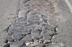 A road in the Eagle Ford Shale area in South Texas. The natural gas drilling boom is straining the region's rural roads. More than 1,000 loaded trucks are needed to bring a single well into production.