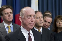 Surrounded by several Texas legislators, Dr. Steve Hotze announces his lawsuit targeting the Affordable Care Act on May 7, 2013.