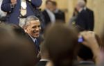 President Barack Obama greets the audience at Applied Materials, Inc. after delivering his remarks.