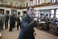 Gov. Rick Perry leaves the House chamber after speaking and visiting with members on May 13, 2013.