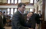 Gov. Rick Perry hugs State Rep. Marisa Marquez, D-El Paso, during a visit to the House chamber of May 13, 2013.
