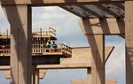 Construction workers working on an elevated section of Chisholm Trail Parkway near downtown Fort Worth TX.