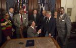 Gov. Rick Perry ceremonially signs Senate Bill 1611, known as the Michael Morton Act, which requires prosecutors to disclose evidence in criminal cases. Morton served nearly 25 years in prison for his wife's murder before he was exonerated in 2011.