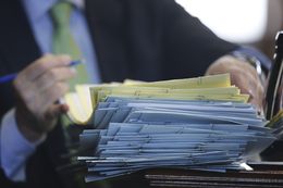 Lt. Governor David Dewhurst signs a stack of bills during a recess in the Senate session on May 22, 2013.