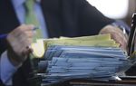 Lt. Governor David Dewhurst signs a stack of bills during a recess in the Senate session on May 22, 2013.