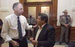 Small business owner Reynaldo Gutierrez who heckled Gov. Perry at an earlier event at, speaks to Rich Parsons, deputy director of Communications for Gov. Perry outside the Governor's reception room on May 22nd , 2013.