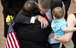 Gov. Rick Perry hugs the family of fallen Marine Sgt. Lorenzo Aranda, Jr. at the Capitol memorial for fallen servicemen on May 25, 2013.