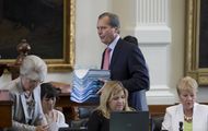 Lt. Gov. David Dewhurst delivers a stack of bills to the secretary of the Senate on May 27, 2013.